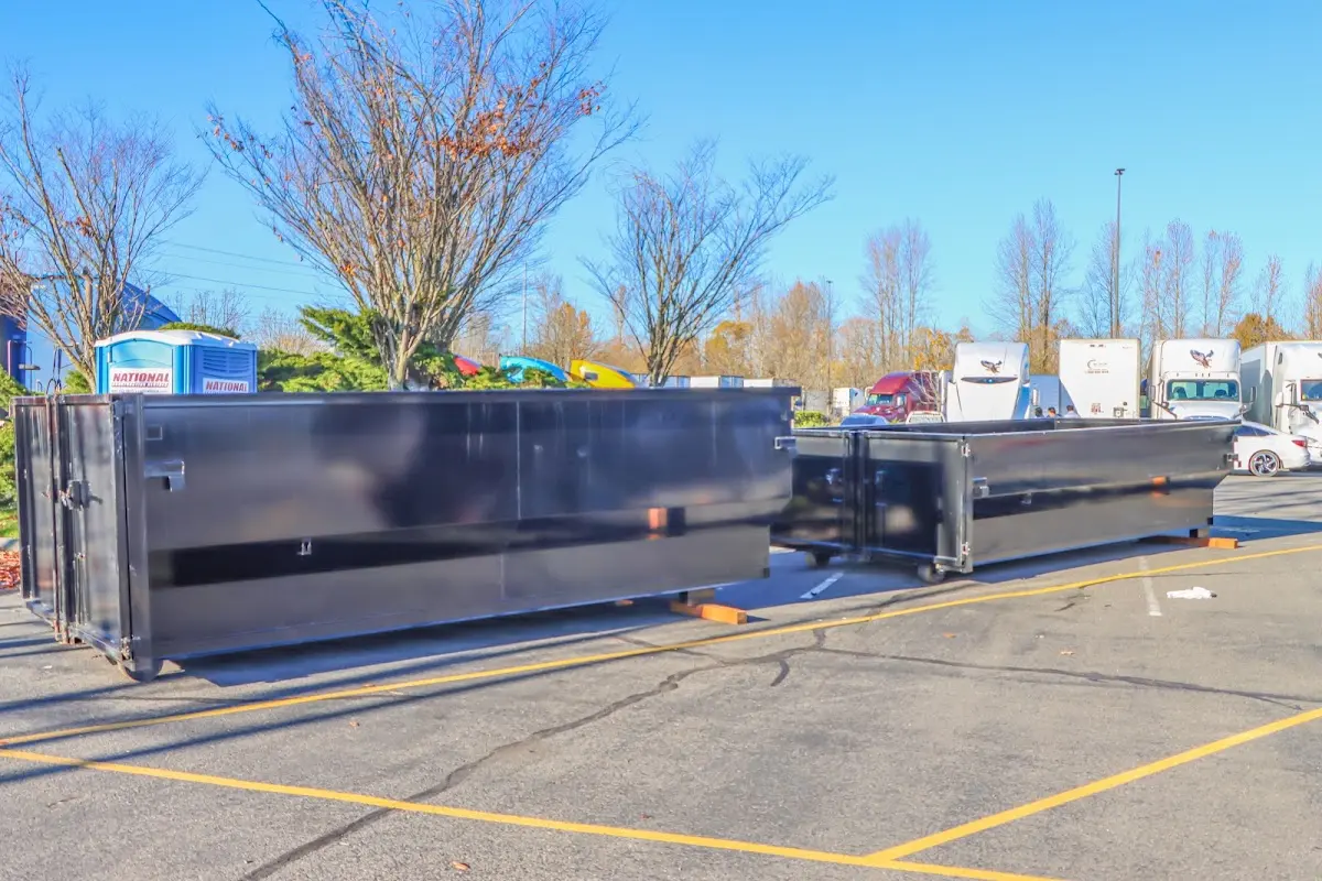 Professional dumpster rental service with roll-off container on residential driveway in Lansdowne
